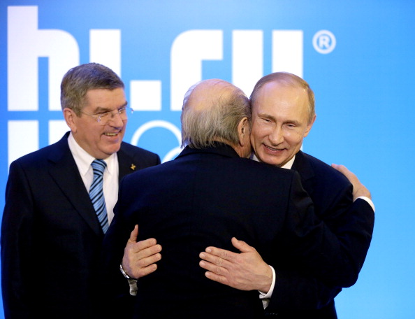 Sepp Blatter, seen here embracing Russian President Vladimir Putin watched by IOC chief Thomas Bach, does not believe anyone should be forced to step down because of their age ©Getty Images 