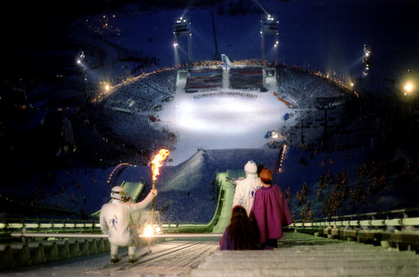 The Lillehammer 1994 Opening Ceremony's pièce de résistance came when the Olympic Torch was taken down the ski-jump by an athlete dressed in white on its way to the cauldron ©Getty Images