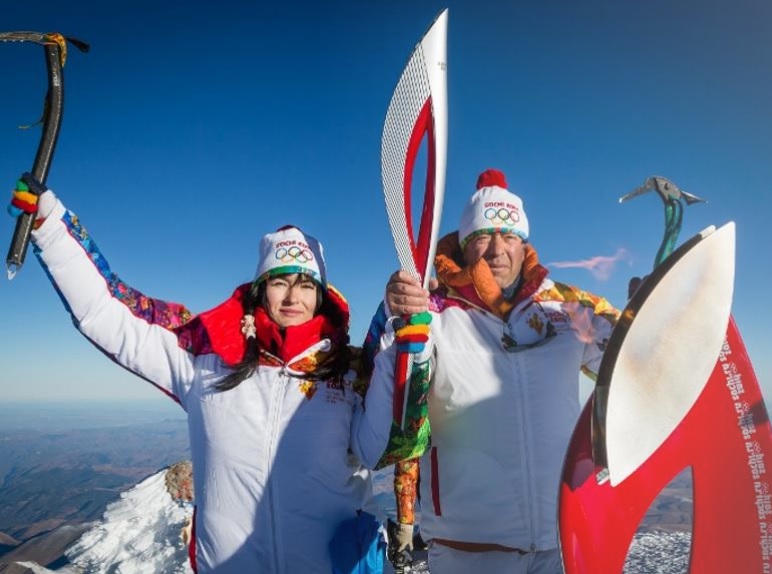 The Olympic Torch is held aloft when it was lit on top of Mt Elbrus in October ©Sochi 2014