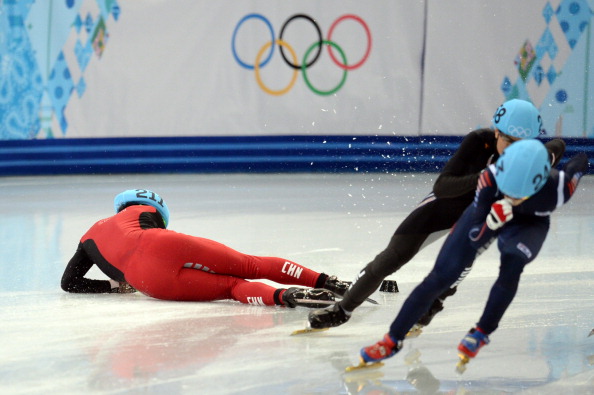 China's Shi Jingnani falls as he competes in the men's short track 1500m heats ©AFP/Getty Images