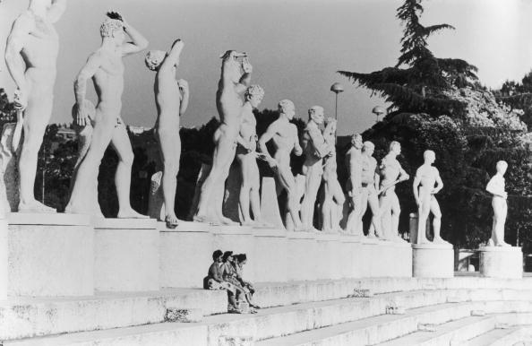 A group of women sit beneath statues at the Olympic Stadium before the Rome 1960 Olympics, to which David Wallechinsky was taken by his father, Irving Wallace. Wallechinsky-style detail: the statues were originally put up by Mussolini but had been declared indecent by the Italian Church ©Hulton/ Getty Images