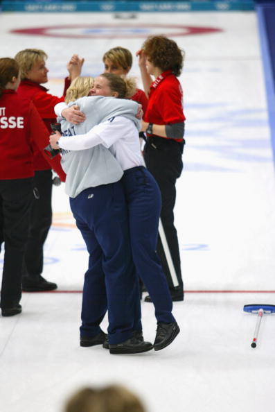 Rhona Martin is embraced in the moment of victory by team-mate Fiona MacDonald as their Swiss opponents, whose honourable victory over Germany in their final pool match let Britain back into the tournament, commiserate with each other ©Getty Images