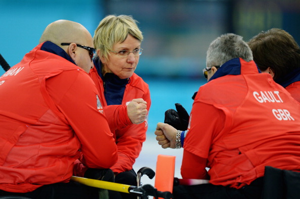 Great Britain discuss tactics midway through their epic comeback victory over the US in curling ©Getty Images