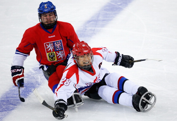 Jong-Kyung Lee of Korea (right) collides with Michal Geier of Czech Republic during their ice sledge hockey match ©Getty Images