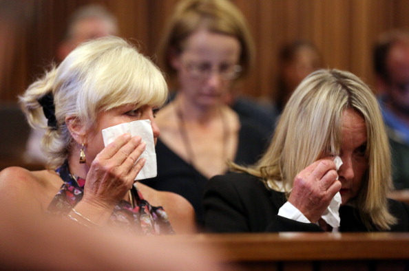 June Steenkamp (right), mother of Reeva Steenkamp, and her her long time friend Jenny Strydom cry as cctv footage is shown of Steenkamp and Pistorius kissing whilst shopping for groceries ©AFP/Getty Images