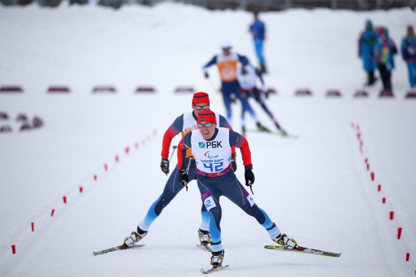 Nikolay Polukhin leading his guide home to win the 15km visually impaired event Medals action in super-combined and biathlon ©Getty Images