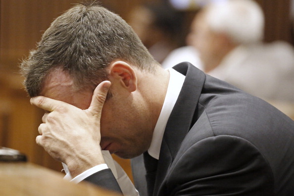 Oscar Pistorius reacts during the fifth day of his trial for the murder of his girlfriend Reeva Steenkamp ©AFP/Getty Images