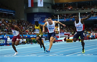 Britain's Richard Kilty wins the gold medal with team mate Dwain Chambers (right), Qatar's Femi Ogunode (left) and Jamaica's Nesta Carter in the men's 60m at the World Indoor Championships ©Getty Images