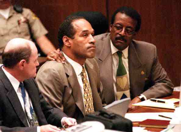 O J Simpson (centre) at his trial for the murder of his estranged wife Nicole Brown and her friend Ronald Goldman. Simpson is pictured with two members of his defence counsel - Johnnie Cochran (right) and Robert Blasier ©AFP/Getty Images