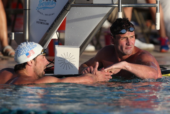 Michael Phelps (left) congratulates compatriot Ryan Lochte after being pipped to the 100m butterfly race win ©Getty Images