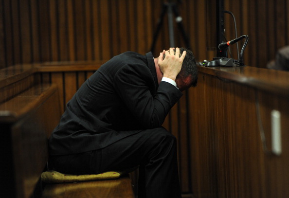Oscar Pistorius lowered his head as graphic details of his girlfriend Reeva Steenkamp's injuries were given in court ©Getty Images