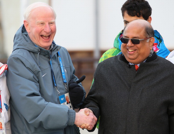 Patrick Hickey shakes hands with newly elected Indian Olympic Association President Narayna Ramachandra uring the welcome ceremony and flag raising at the Olympic Village during Sochi 2014 ©AFP/Getty Images