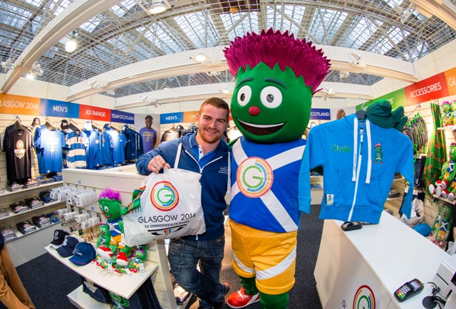 Team Scotland weightlifter Peter Kirkbride joins Glasgow 2014 mascot Clyde at the opening of the first official merchandise store at Central Station ©Glasgow 2014