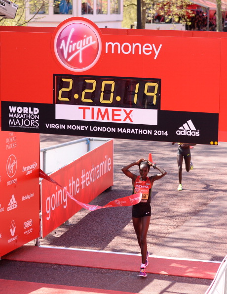 Kenya's Edna Kiplagat celebrates winning the Virgin London Marathon ahead triple Olympic gold medallist Tirunesh Dibaba ©Getty Images