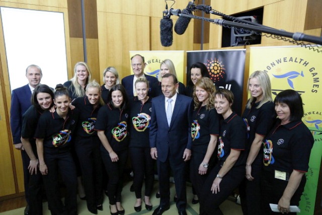 Australian Prime Minister Tony Abbott (centre) is flanked by the Australian netball team that will be going for gold in Glasgow this summer ©Getty Images 
