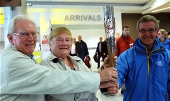 Commonwealth Games Council of Wales chief executive Chris Jenkins shows off the Queen's Baton Relay as it arrives at Cardiff Wales Airport today ©Getty Images 