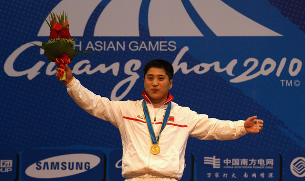 North Korea's Kim Kum Sok celebrates his gold medal win in the men's weightlifting 69kg competition at Guangzhou 2010 ©Getty Images