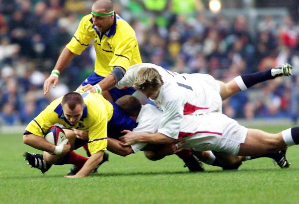 Alin Petrache being tackled in his playing days by an English opponent during a match in 2001 ©AFP/Getty Images