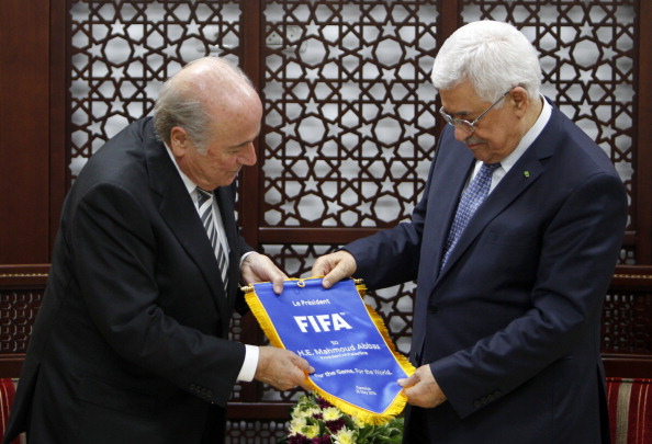 Sepp Blatter presented Palestinian President Mahmoud Abbas with a FIFA club flag during his visit ©AFP/Getty Images