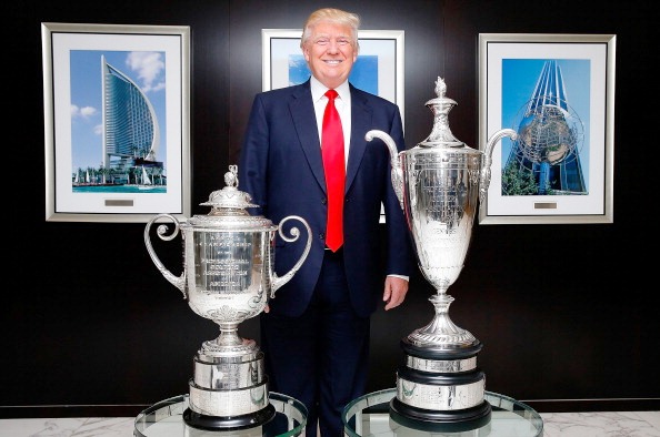Trump poses with the USPGA trophy and USPGA Senior trophy in New York ©Getty Images 
