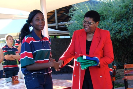 Vezembauua Mauano, who will lead out her team at the Opening Ceremony as flagbearer, receiving the flag from Namibia National Olympic Committee president Agnes Tjongarero ©Proactive
