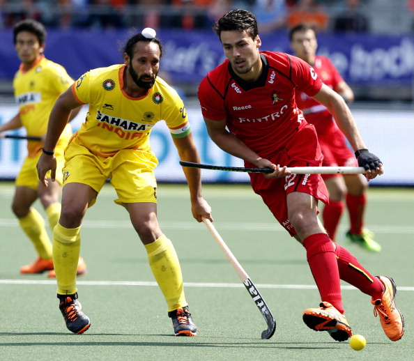 India's Surdar Singh challenges Belgium's Simon Gougnard during the opening round of the Hockey World Cup in a match won 3-2 by Belgium ©AFP/Getty Images