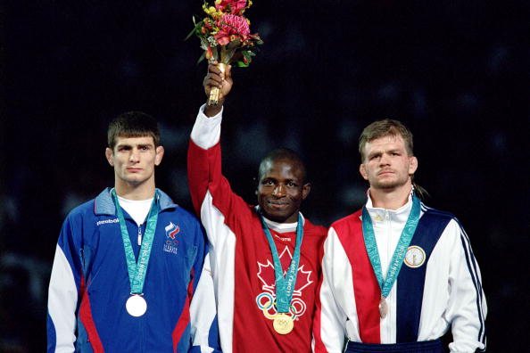 Daniel Igali (centre) won Olympic gold at Sydney 2000 ahead of Russia's Arsen Gitinov and Lincoln McIlravy of the United States ©Getty Images