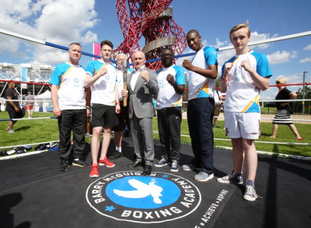 Former Commonwealth Games boxing gold medallist Barry McGuigan (centre) meets six of the Batonbearers in the Olympic Park today ©Getty Images