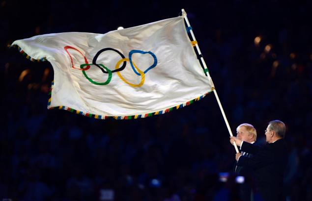 The Olympic flag and rings, seen here being waved by then IOC President Jacques Rogge at London, celebrates its centenary this week ©Getty Images