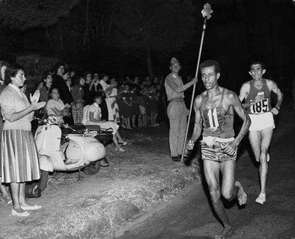 Abebe Bikila of Ethiopia en route for the marathon title at the Rome 1960 Olympics, pursued by Morocco's Abdesselam Rhadi. His barefoot exploits inspired a 12-year-old Foster, watching on television, to become a runner ©Hulton Archive/Getty Images