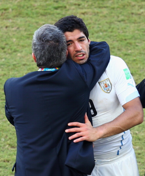 A dejected Luis Suarez gets a hug from Uruguay's coach Oscar Tabarez after the 1-0 win over Italy in which he appeared to bite an opponent ©AFP/Getty Images