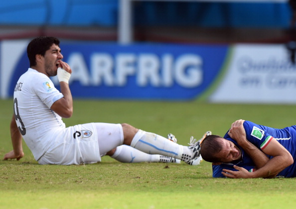 Luis Suarez holds his mouth, Giorgio Chiellini holds his shoulder - the aftermath of the incident for which the Uruguayan forward was banned for four months by FIFA ©AFP/Getty Images