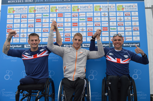 Jetze Plat of the Netherlands (centre) celebrates his paratriathlon gold medal in the PT1 event at the European Championships in Kitzbuhel today ©ETU