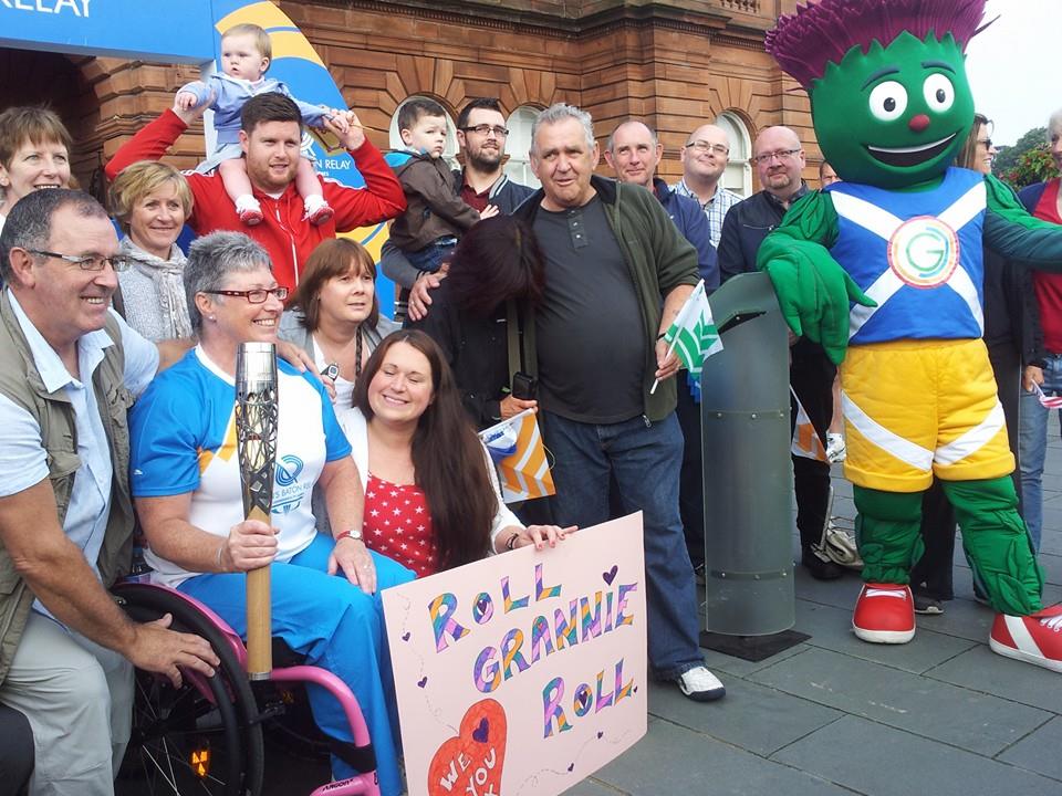 Anne-Marie Monaghan, pictured with enthusiastic friends and family members, as well as Glasgow 2014 mascot Clyde, before carrying the Baton on to the streets of Glasgow ©ITG