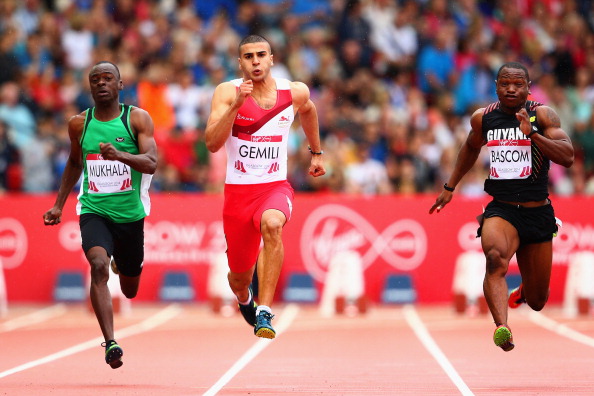England's Adam Gemili (centre) set the fastest time in the heats of the men's 100m, crossing the line in 10.15 ©Getty Images