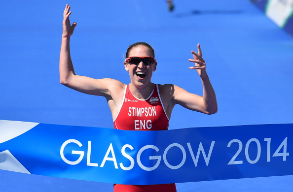 A beaming Jodie Stimpson of England crossed the finish line of the women's triathlon to win the first gold medal of Glasgow 2014 ©Getty Images