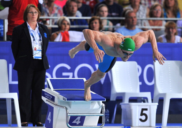 Cameron van der Burgh of South Africa diving into the water at the start of the men's 50m breaststroke final, a race he narrowly won ©AFP/Getty Images 