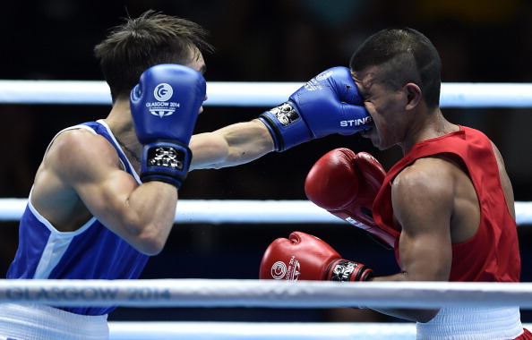 Northern Ireland's Michael Conlan landing a punch to the face of Nauru's Mathew Martin on his way to winning their 56kg boxing bout ©AFP/Getty Images
