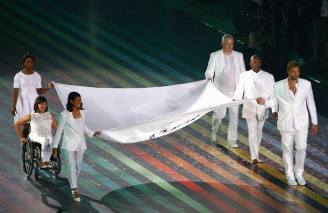 The Commonwealth Games Federation Flag was carried on by some of the Commonwealth's greatest ever athletes at Celtic Park tonight ©Getty Images 