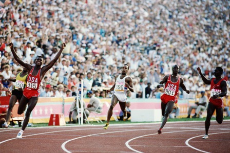 Carl Lewis of the United States celebrates after winning the 100 metres at Los Angeles 1984 ©Steve Powell/Getty Images