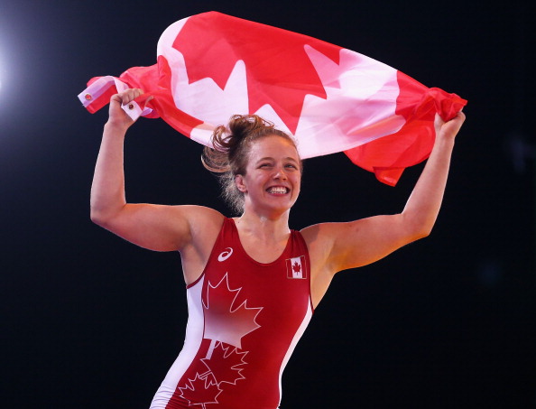 A delighted Dori Yeats flying the Canadian flag with pride after winning gold in the women's 69kg wrestling ©Getty Images