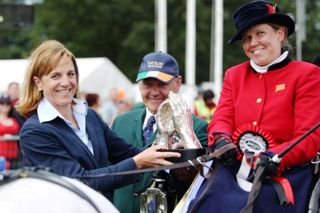 Director of driving, vaulting and reining at the FEI, Bettina De Rham (left) presents the Princess Haya Hand-in-Hand Trophy to Ireland's Barry Capstick and Lindsey Tyas Paice of Britain ©Marie de Ronde-Oudemans/FEI