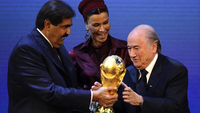 FIFA President Sepp Blatter hands over the World Cup trophy to the then Emir of Qatar, Sheikh Hamad bin Khalifa al-Thani and his wife Chair, after the country had been awarded the 2022 tournament ©AFP/Getty Images