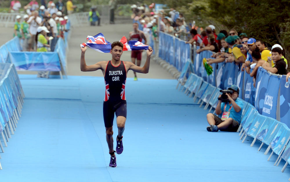 Ben Dijkstra crossed the finish line with the Union Flag in his hands to win the triathlon mixed relay for Great Britain ©Nanjing 2014