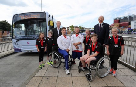 Budding Paralympians pose alongside officials and established athletes, Nathan Stephens and Kyron Duke, to publicise transport arrangements for the IPC European Athletics Championships ©First Cymru