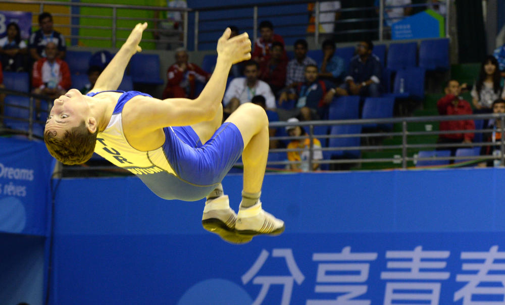 Cabbar Duyum of Turkey does a backflip to celebrate securing bronze in the men's freestyle 46kg ©Nanjing 2014