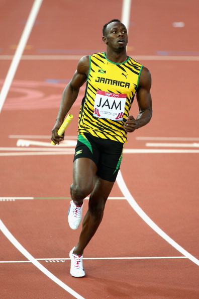 Usain Bolt crosses the line to lead Jamaica to victory in their relay heat ©Getty Images