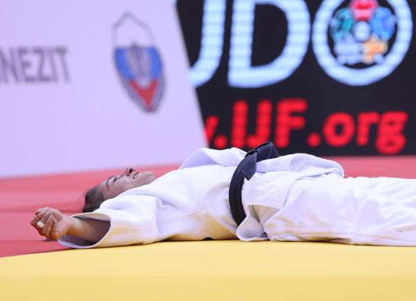 Majlinda Kelmendi slumps to the tatami after retaining her under-52kg World Championships title ©IJF