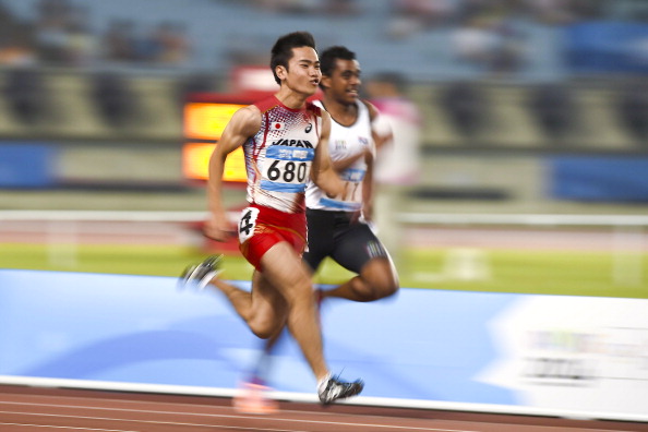 Kenta Oshima of Japan powered towards the finish line in his heat of the men's 100m ©Nanjing 2014