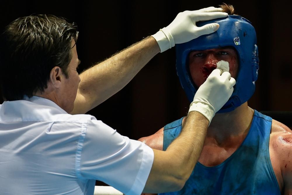 Tregren Vegar Berk of Norway getting medical treatment during the men's light heavyweight preliminaries ©Getty Images